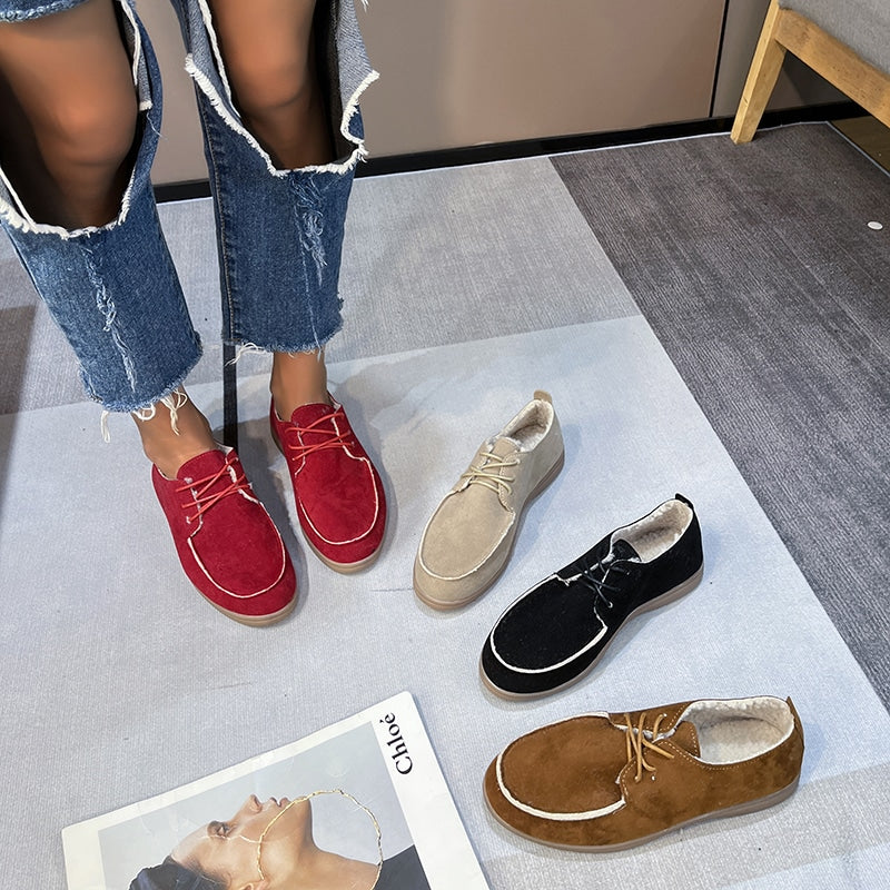 mocassino di colore diverso con piedi di donna e un libro
