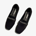 Mocassini in camoscio nero con catena di strass su sfondo bianco